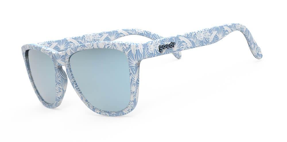 Side view blue frames with all over palm leaf print and blue lens sunglasses with polarized, uv protection, and reflective lenses